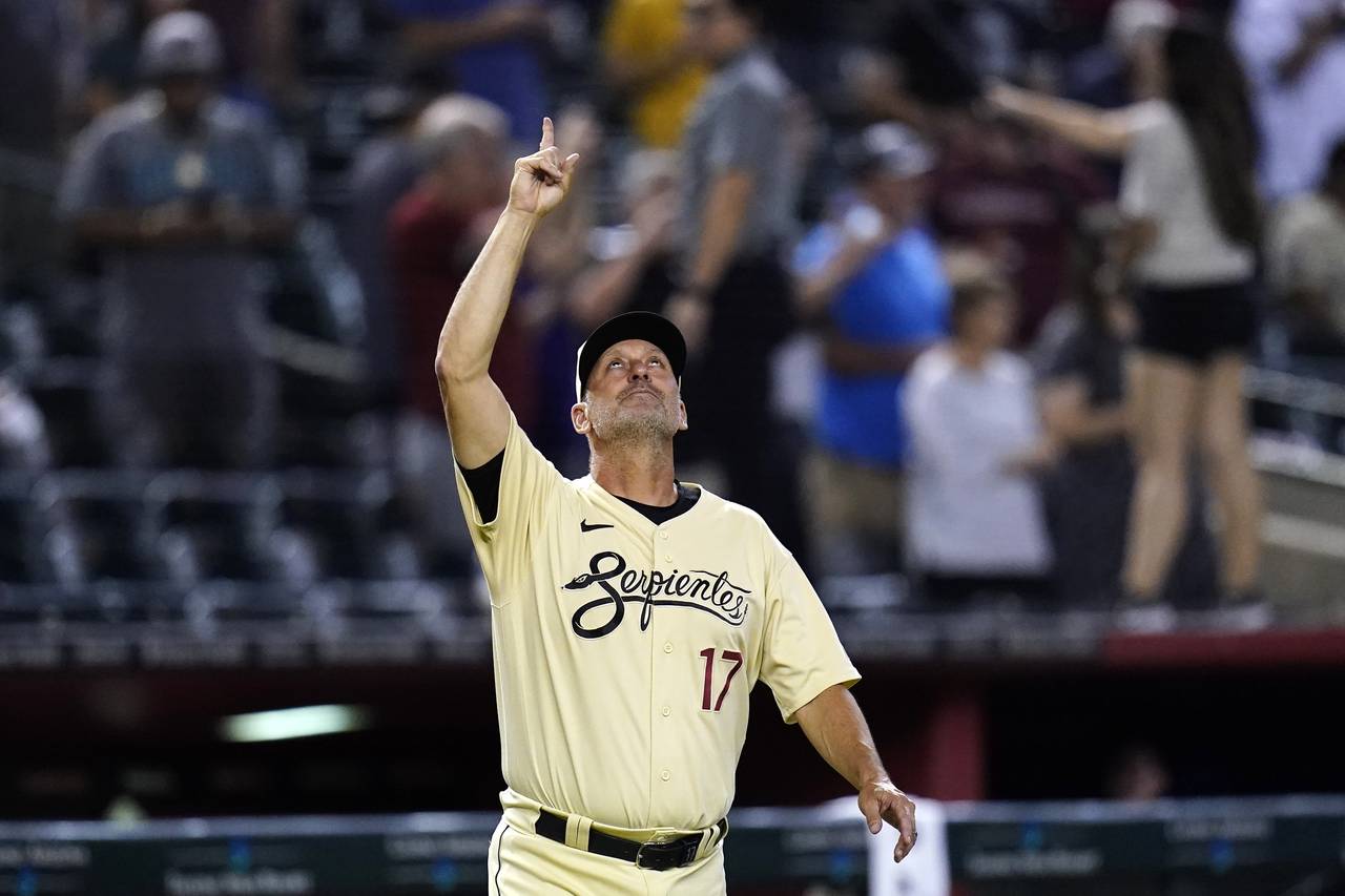 Arizona Diamondbacks manager Torey Lovullo points to the sky as he comes out of the dugout after th...