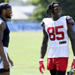 
              Tennessee Titans running back Derrick Henry, left, talks with Tampa Bay Buccaneers wide receiver Julio Jones (85) after a combined NFL football training camp Thursday, Aug. 18, 2022, in Nashville, Tenn. (AP Photo/Mark Zaleski)
            