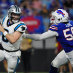 
              Carolina Panthers quarterback Baker Mayfield breaks away from Buffalo Bills defensive end Mike Love during the first half of an NFL preseason football game on Friday, Aug. 26, 2022, in Charlotte, N.C. (AP Photo/Jacob Kupferman)
            