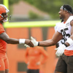 
              Cleveland Browns quarterback Deshaun Watson, left, shakes hands with defensive end Myles Garrett during the NFL football team's training camp, Monday, Aug. 1, 2022, in Berea, Ohio. (AP Photo/Nick Cammett)
            