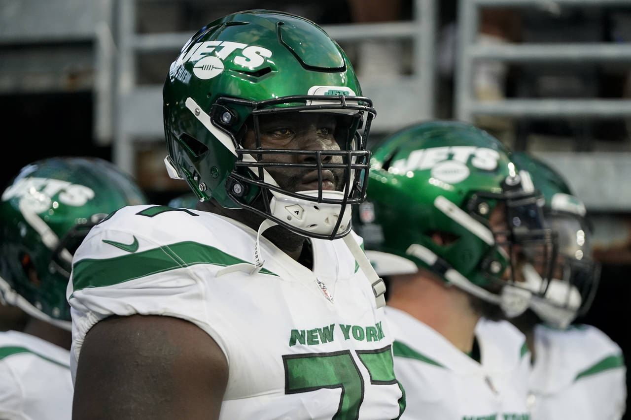 FILE - New York Jets offensive tackle Mekhi Becton waits to take the field before an NFL preseason ...