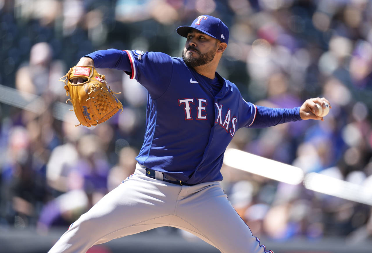 Texas Rangers starting pitcher Martin Perez works against the Colorado Rockies in the second inning...