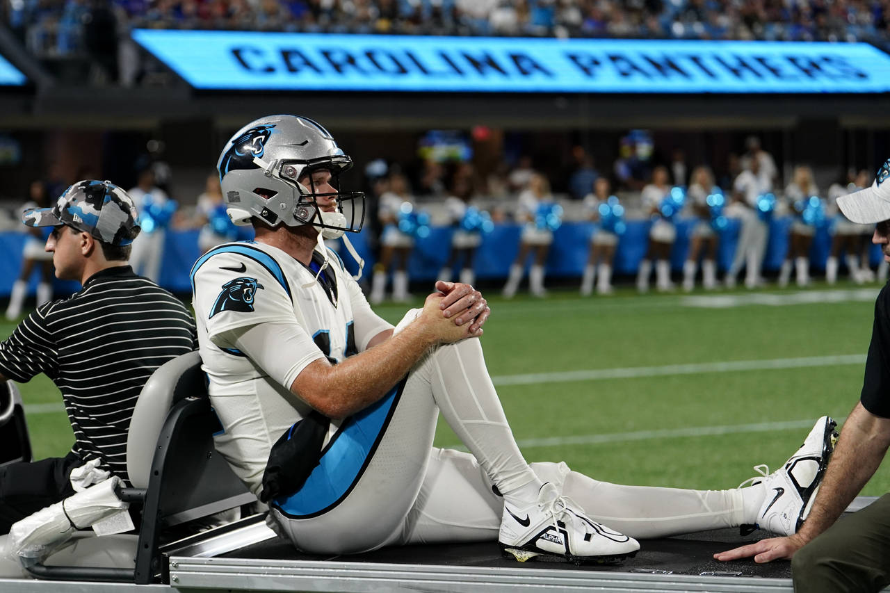 Carolina Panthers quarterback Sam Darnold leaves the field on a cart after getting injured during t...