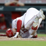 
              Cincinnati Reds' Jake Fraley falls to the ground after a foul ball hit him on the leg during the fifth inning of the team's baseball game against the Philadelphia Phillies in Cincinnati on Tuesday, Aug. 16, 2022. (AP Photo/Paul Vernon)
            