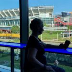 
              Retired firefighter Michelle Krause checks her phone during a break at the American Massage Therapist Association national convention at the Huntington Convention Center in Cleveland, Ohio, Thursday, Aug. 25, 2022. In the background is FirstEnergy Stadium, home of the Cleveland Browns NFL football team. (AP Photo/Teresa Walker)
            