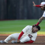 
              Chicago Cubs' Willson Contreras grabs his ankle as he is tagged out by Cincinnati Reds second baseman Jonathan India (6) in the third inning during a baseball game at the Field of Dreams movie site, Thursday, Aug. 11, 2022, in Dyersville, Iowa. (AP Photo/Charlie Neibergall)
            