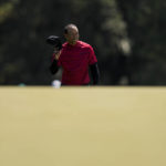 
              FILE - Tiger Woods tips his cap as he walks to the 18th green during the final round at the Masters golf tournament on Sunday, April 10, 2022, in Augusta, Ga. Max Homa says the moment illustrated someone who doesn't need money playing because of passion. (AP Photo/Jae C. Hong, File)
            