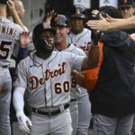 
              Detroit Tigers left fielder Akil Baddoo (60) celebrates with teammates after scoring during the second inning of a baseball game against the Chicago White Sox, Saturday, Aug. 13, 2022, in Chicago. (AP Photo/Matt Marton)
            