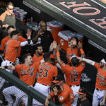 
              Baltimore Orioles' Rougned Odor (12) is greeted by teammates after scoring a run on a single by Jorge Mateo against Pittsburgh Pirates starting pitcher JT Brubaker during the second inning of a baseball game, Saturday, Aug 6, 2022, in Baltimore. (AP Photo/Terrance Williams)
            