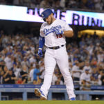 
              Los Angeles Dodgers' Max Muncy scores after hitting a solo home run during the third inning of a baseball game against the Minnesota Twins Tuesday, Aug. 9, 2022, in Los Angeles. (AP Photo/Mark J. Terrill)
            