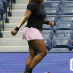 
              Serena Williams looks at a small dog while warming-up before practicing at Arthur Ashe Stadium before the start of the U.S. Open tennis tournament in New York, Thursday, Aug. 25, 2022. (AP Photo/Seth Wenig)
            