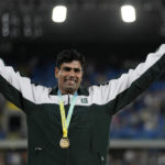 
              Arshad Nadeem of Pakistan poses on the podium after winning the gold medal in the Men's javelin throw during the athletics competition in the Alexander Stadium at the Commonwealth Games in Birmingham, England, Sunday, Aug. 7, 2022. (AP Photo/Alastair Grant)
            