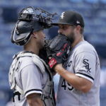 
              Chicago White Sox relief pitcher Kendall Graveman and catcher Seby Zavala meet on the mound during the seventh inning of a baseball game against the Kansas City Royals Monday, Aug. 22, 2022, in Kansas City, Mo. (AP Photo/Charlie Riedel)
            