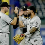 
              Chicago White Sox's Gavin Sheets (32), Lenyn Sosa, center and Yoan Moncada, right, celebrate after the second game of a baseball doubleheader against the Kansas City Royals Tuesday, Aug. 9, 2022, in Kansas City, Mo. The White Sox won 3-2. (AP Photo/Charlie Riedel)
            