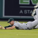 
              Oakland Athletics right fielder Stephen Piscotty dives but cannot make the catch on a pop fly from Los Angeles Angels' Phil Gosselin during the fourth inning of a baseball game Tuesday, Aug. 2, 2022, in Anaheim, Calif. Gosselin drove in a run on the play and was thrown out at second base.(AP Photo/Marcio Jose Sanchez)
            