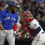 
              Toronto Blue Jays' Vladimir Guerrero reacts to striking out as Minnesota Twins catcher Sandy Leon, right, applies the tag, to end the baseball game Saturday, Aug. 6, 2022, in Minneapolis. The Twins won 7-3. (AP Photo/Bruce Kluckhohn)
            