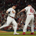 
              St. Louis Cardinals' Tyler O'Neill is congratulated by first base coach Stubby Clapp (82) after hitting a three-run home run during the eighth inning of a baseball game against the Atlanta Braves Sunday, Aug. 28, 2022, in St. Louis. (AP Photo/Jeff Roberson)
            