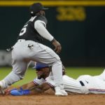 
              Chicago White Sox second baseman Josh Harrison tags out Texas Rangers' Leody Taveras on a stolen-base attempt during the second inning of a baseball game Thursday, Aug. 4, 2022, in Arlington, Texas. (AP Photo/Tony Gutierrez)
            