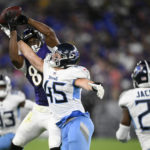 
              Baltimore Ravens tight end Isaiah Likely, top, catches a pass against Tennessee Titans linebacker Chance Campbell during the first half of a preseason NFL football game, Thursday, Aug. 11, 2022, in Baltimore. Titans' Theo Jackson (29) and A.J. Moore (33) look on. (AP Photo/Nick Wass)
            
