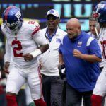 
              New York Giants quarterback Tyrod Taylor (2) runs off the field alongside head coach Brian Daboll, center right, after taking a hard hit from New York Jets defensive end Micheal Clemons (72) in the first half of a preseason NFL football game, Sunday, Aug. 28, 2022, in East Rutherford, N.J. (AP Photo/Julia Nikhinson)
            