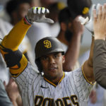 
              San Diego Padres' Juan Soto celebrates with teammates in the dugout after his home run against the San Francisco Giants during the fourth inning of a baseball game Tuesday, Aug. 9, 2022, in San Diego. (AP Photo/Gregory Bull)
            