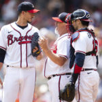 
              Atlanta Braves pitching coach Rick Kranitz, center, and catcher Travis d'Arnaud, right, speak with starting pitcher Charlie Morton, left, in the third inning of a baseball game against the Houston Astros, Sunday, Aug. 21, 2022, in Atlanta. (AP Photo/Hakim Wright Sr.)
            