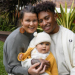 
              Ellia Green with his partner Vanessa Turnbull-Roberts and their daughter Waitui pose in Sydney, Australia, Monday, Aug. 15, 2022. Green, one of the stars of Australia's gold medal-winning women's rugby sevens team at the 2016 Olympics, has transitioned to male. The 29-year-old, Fiji-born Green is going public in a video at an international summit aimed at ending transphobia and homophobia in sport. The summit is being hosted in Ottawa as part of the Bingham Cup rugby tournament. (AP Photo/Mark Baker)
            