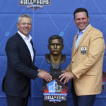 
              Former NFL player Tony Boselli, right, and presenter Mark Brunell pose with his bust during an induction ceremony at the Pro Football Hall of Fame in Canton, Ohio, Saturday, Aug. 6, 2022. (AP Photo/David Dermer)
            