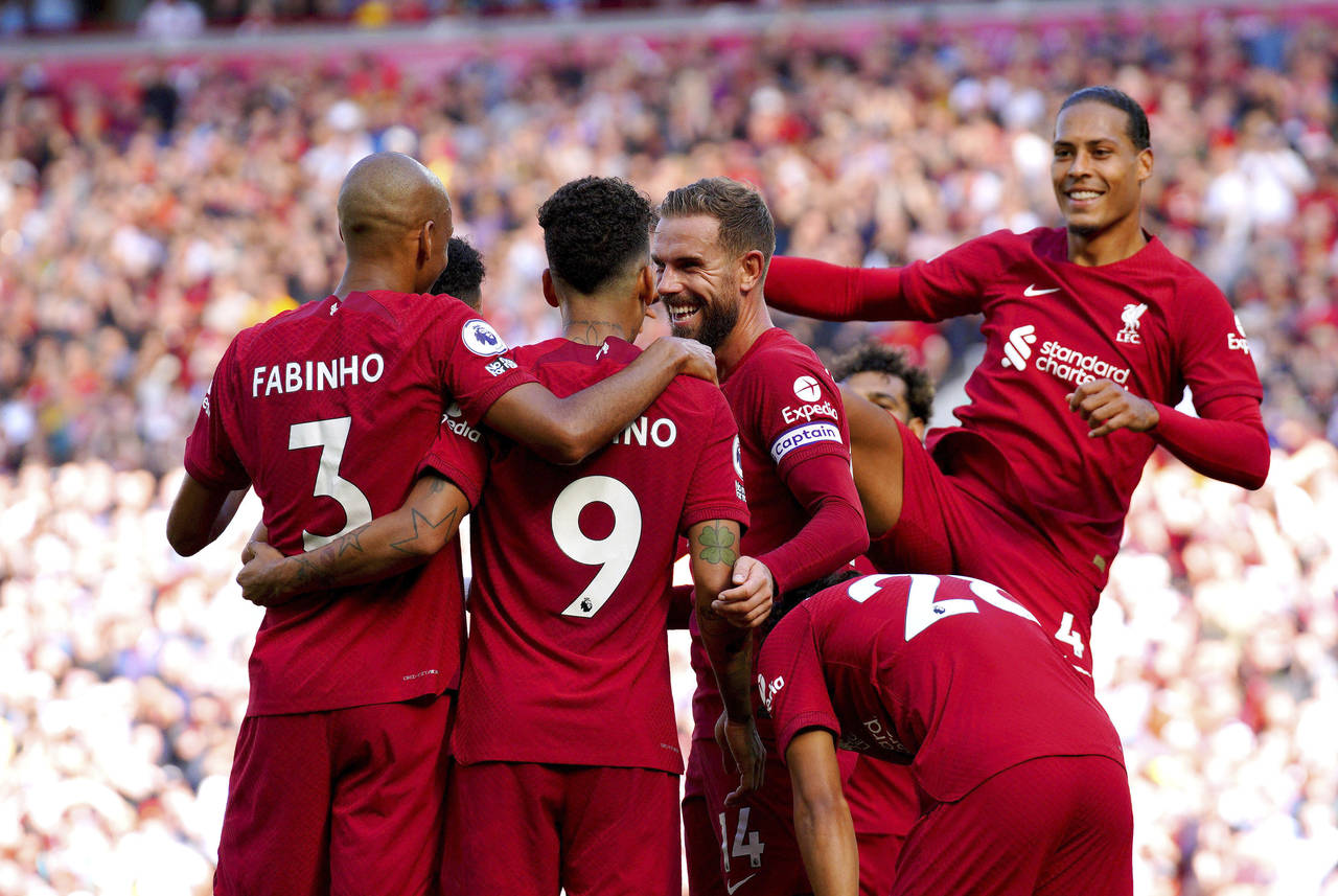 Liverpool's Roberto Firmino celebrates with his team-mates after scoring their side's seventh goal ...