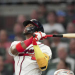 
              Atlanta Braves' Ronald Acuna Jr. watches his RBI double during the second inning of the team's baseball game against the New York Mets on Monday, Aug. 15, 2022, in Atlanta. (AP Photo/John Bazemore)
            