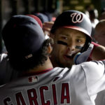 
              Washington Nationals' Luis Garcia hugs Joey Meneses in the dugout after Meneses' two-run home run off Chicago Cubs relief pitcher Mark Leiter Jr. during the eighth inning of a baseball game Tuesday, Aug. 9, 2022, in Chicago. (AP Photo/Charles Rex Arbogast)
            