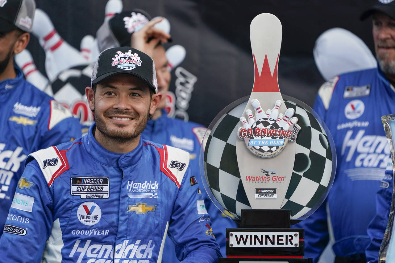 Kyle Larson smiles with his trophy after winning a NASCAR Cup Series auto race in Watkins Glen, N.Y...