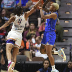 
              Phoenix Mercury guard Skylar Diggins-Smith (4) blocks a shot by Connecticut Sun guard Courtney Williams (10) during a WNBA basketball game Tuesday, Aug. 2, 2022, in Uncasville, Conn. (Sean D. Elliot/The Day via AP)
            