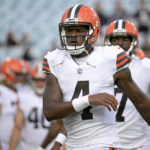 
              FILE - Cleveland Browns quarterback Deshaun Watson warms up before a preseason NFL football game against the Jacksonville Jaguars, Aug. 12, 2022, in Jacksonville, Fla. A person familiar with the situation tells The Associated Press on Thursday, Aug. 18, 2022, that Watson has reached a settlement with the NFL and will serve an 11-game suspension and pay a $5 million fine rather than risk missing his first season as quarterback of the Browns following accusations of sexual misconduct while he played for the Houston Texans.  (AP Photo/Phelan M. Ebenhack, File)
            