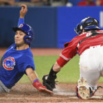 
              Toronto Blue Jays catcher Danny Jansen, right, tags out Chicago Cubs' Nick Madrigal, left, at home plate in fifth-inning baseball game action in Toronto, Monday, Aug. 29, 2022. (Jon Blacker/The Canadian Press via AP)
            