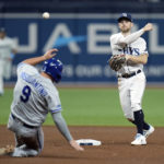 
              Tampa Bay Rays second baseman Brandon Lowe forces Kansas City Royals' Vinnie Pasquantino (9) at second base and relays the throw to first in time to turn a double play on Brent Rooker during the sixth inning of a baseball game Friday, Aug. 19, 2022, in St. Petersburg, Fla. (AP Photo/Chris O'Meara)
            