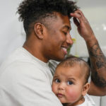 
              Ellia Green is pictured with his daughter Waitui in Sydney, Australia, Monday, Aug. 15, 2022. Green, one of the stars of Australia's gold medal-winning women's rugby sevens team at the 2016 Olympics, has transitioned to male. The 29-year-old, Fiji-born Green is going public in a video at an international summit aimed at ending transphobia and homophobia in sport. The summit is being hosted in Ottawa as part of the Bingham Cup rugby tournament. (AP Photo/Mark Baker)
            