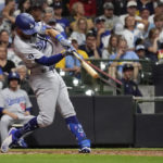 
              Los Angeles Dodgers' Chris Taylor hits a solo home run during the seventh inning of the team's baseball game against the Milwaukee Brewers on Tuesday, Aug. 16, 2022, in Milwaukee. (AP Photo/Aaron Gash)
            