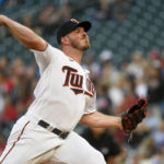 
              Minnesota Twins pitcher Dylan Bundy throws to a Texas Rangers batter during the first inning of a baseball game Friday, Aug. 19, 2022, in Minneapolis. (AP Photo/Craig Lassig)
            
