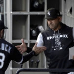 
              Chicago White Sox bench coach Miguel Cairo greets AJ Pollock after the White Sox announced that Cairo would manage the team in the absence of manager Tony La Russa, who will undergo further medical testing at the direction of his doctors with an undisclosed illness, before a baseball game against the Kansas City Royals on Tuesday, Aug. 30, 2022, in Chicago. (AP Photo/Charles Rex Arbogast)
            