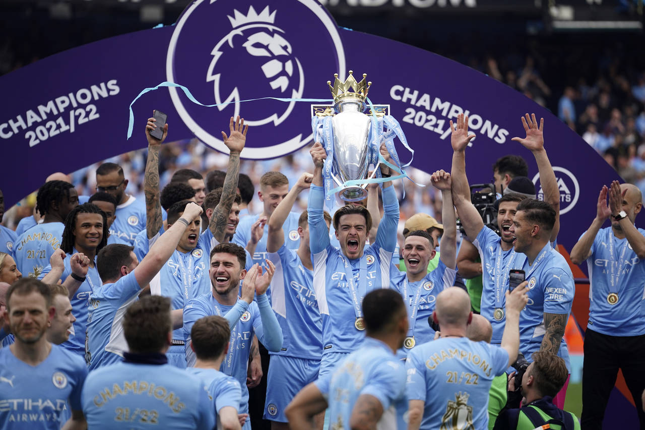 FILE - Manchester City players celebrate with trophy after winning the 2022 English Premier League ...