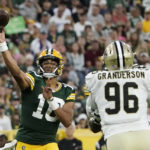 
              Green Bay Packers quarterback Jordan Love (10) passes under pressure from New Orleans Saints defensive end Carl Granderson (96) during the first half of a preseason NFL football game Friday, Aug. 19, 2022, in Green Bay, Wis. (AP Photo/Morry Gash)
            