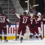 
              Latvia players celebrate a win over Czechia during third-period IIHF world junior hockey championship game action in Edmonton, Alberta, Sunday, Aug. 14, 2022. (Jason Franson/The Canadian Press via AP)
            