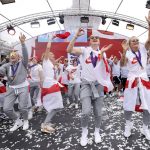 
              England players celebrate on stage at an event at Trafalgar Square in London, Monday, Aug. 1, 2022. England beat Germany 2-1 and won the final of the Women's Euro 2022 on Sunday.  (James Manning/PA via AP)
            