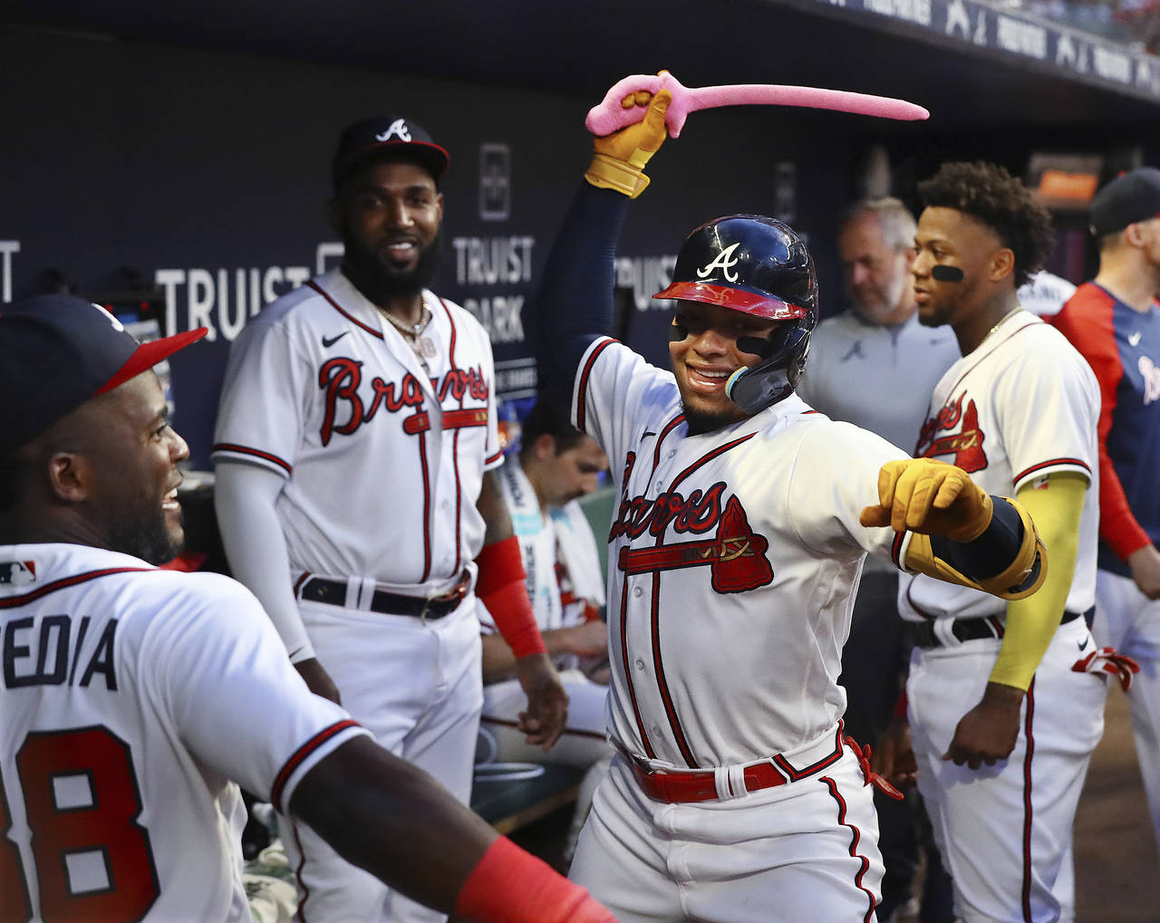 Atlanta Braves' William Contreras swings the pink sword in the dugout after his home run against th...