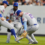 
              New York Mets' Jeff McNeil (1) and Starling Marte (6) watch as first baseman Pete Alonso (20) loses control of a ball hit by New York Yankees' Jose Trevino during the seventh inning of a baseball game Tuesday, Aug. 23, 2022, in New York. (AP Photo/Frank Franklin II)
            