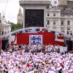 
              England players celebrate on stage at an event in Trafalgar Square in London, Monday, Aug. 1, 2022. England beat Germany 2-1 and won the final of the Women's Euro 2022 on Sunday.  (Steven Paston/PA via AP)
            