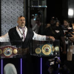 
              Ukraine's Oleksandr Usyk poses between champion belts before his joint press conference with Britain's Anthony Joshua in Jeddah, Saudi Arabia, Wednesday, Aug. 17, 2022. Joshua is due to fight defending champion Usyk in a heavyweight boxing rematch in Jeddah on Aug. 20. (AP Photo/Hassan Ammar)
            