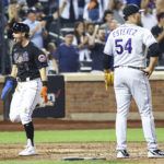 
              New York Mets' Jeff McNeil, left, reacts after scoring off an RBI by Mark Canha as Colorado Rockies relief pitcher Carlos Estevez (54) looks on during the eighth inning of a baseball game on Friday, Aug. 26, 2022, in New York. (AP Photo/Jessie Alcheh)
            