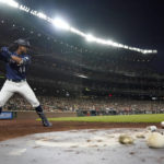 
              Seattle Mariners' Julio Rodriguez stands near the on-deck circle as he waits for an at-bat against the Washington Nationals during the fifth inning of a baseball game, Tuesday, Aug. 23, 2022 in Seattle. Rodriguez struck out swinging on the at-bat. (AP Photo/Ted S. Warren)
            